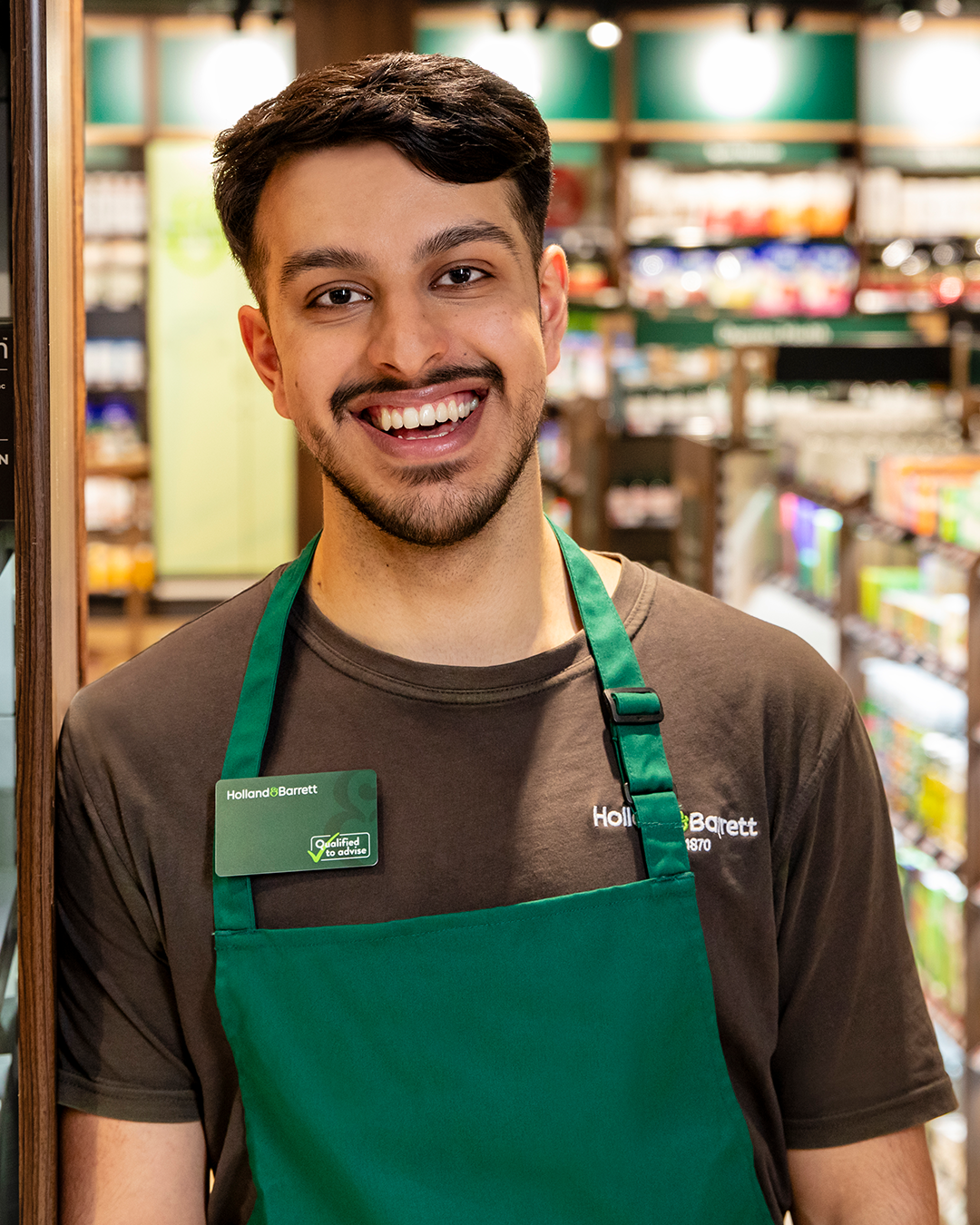 Male store colleague with happy expression