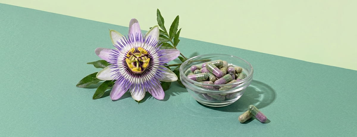 passionflower and tablet on green background
