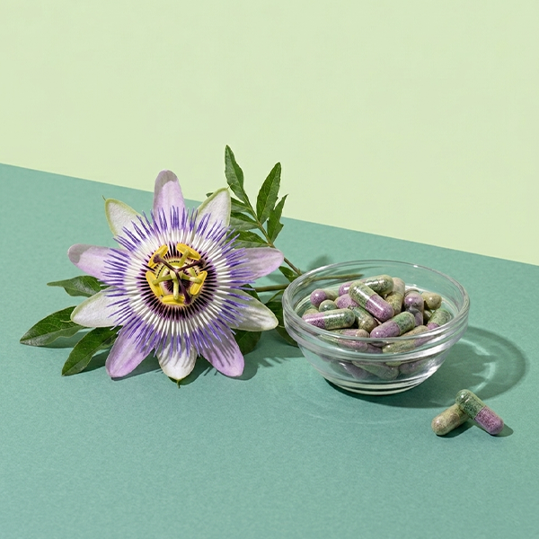 passionflower and tablet on green background