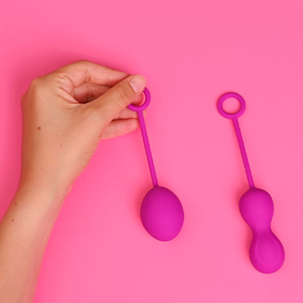Pelvic floor exercise equipment on pink background
