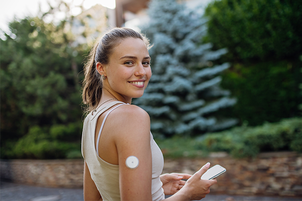 Female with blood test patch on arm