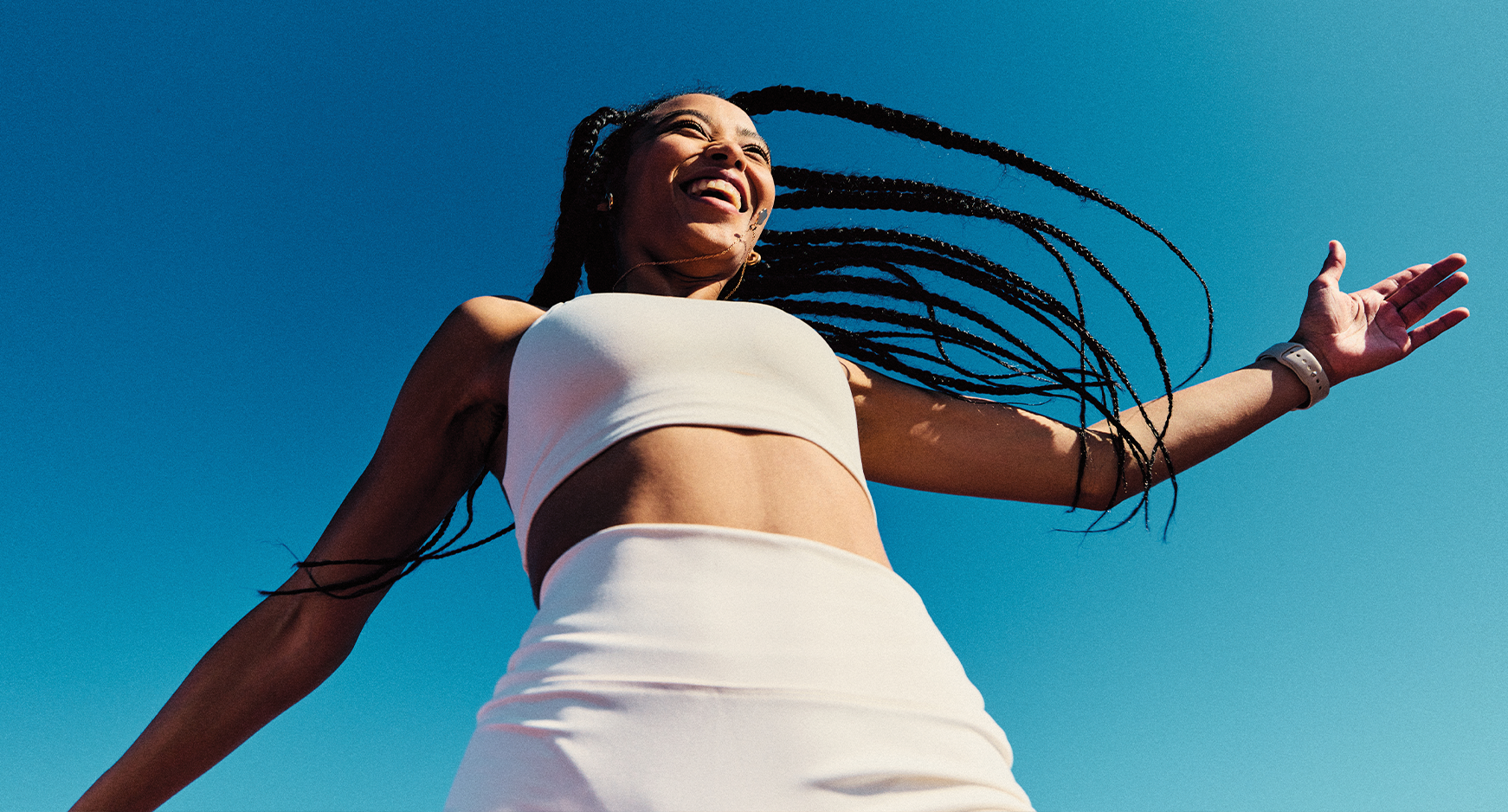 Female in workout clothes, outdoors with happy expression