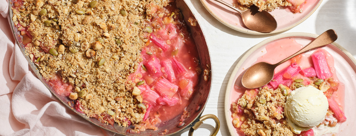 Rhubarb crimble in a metal dish tray with a scoop of vanilla ice cream on the side