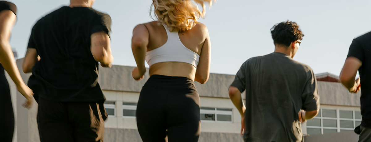 Run club from behind running away from camera 4 adults.