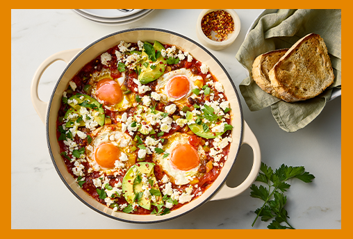 Shaksuka in a white bowl on a marble table
