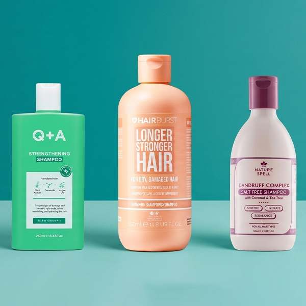 Selection of shampoo and conditioners on blue background