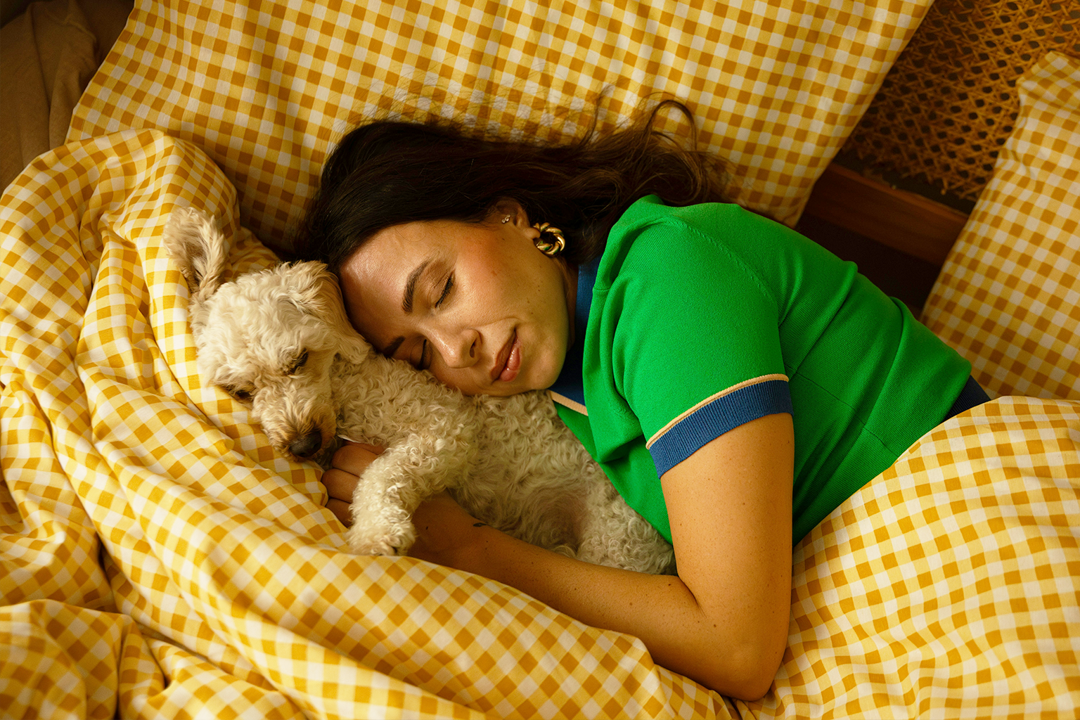 Female and dog asleep in the bed