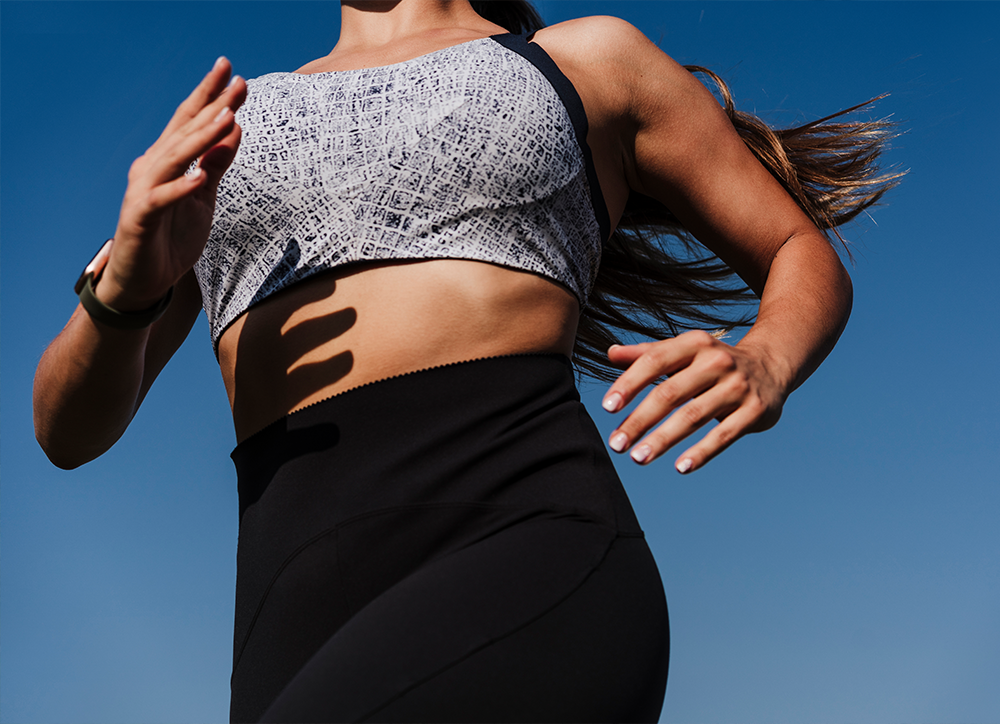 Female running with blue sky behind