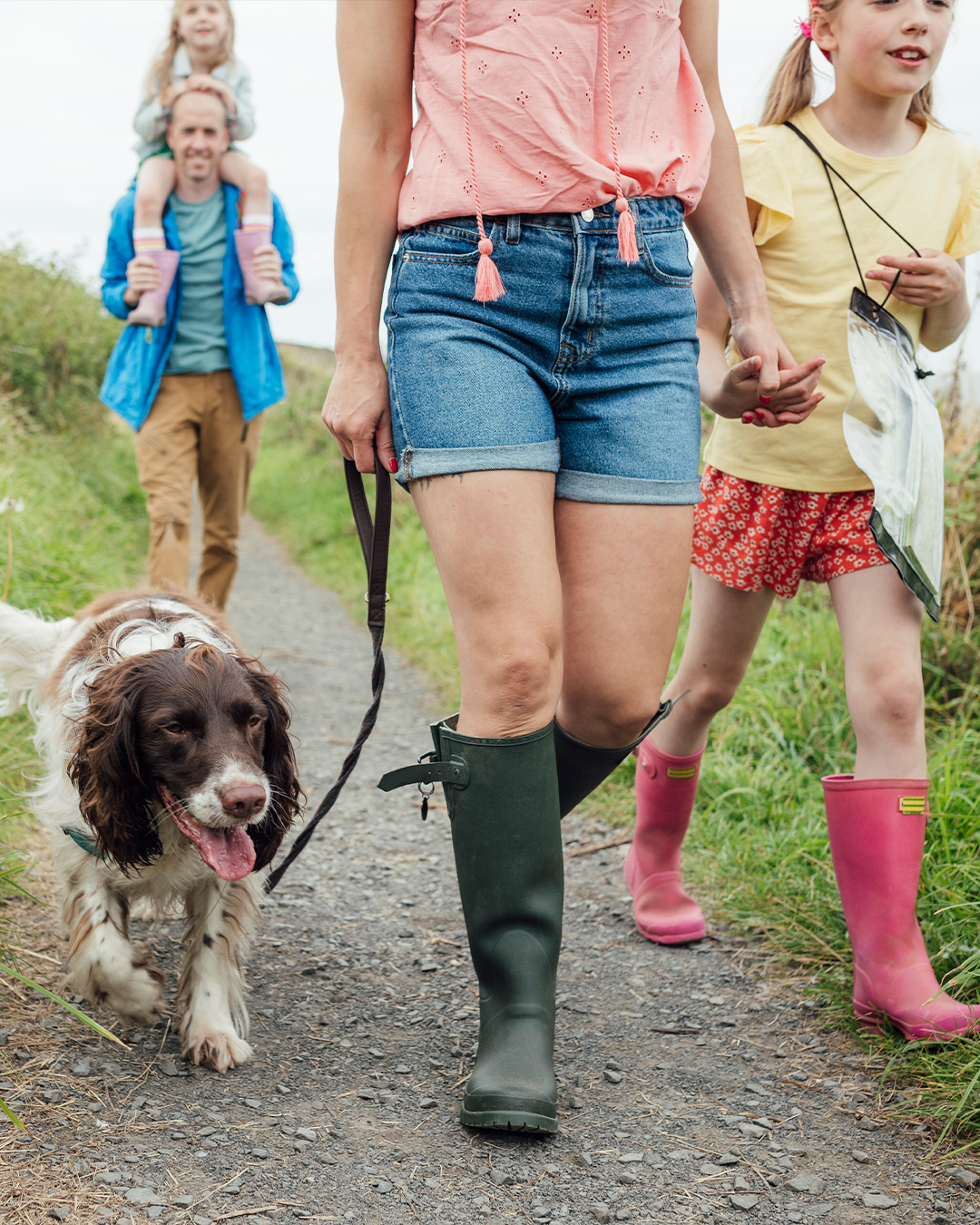 Family with dog walking in the park