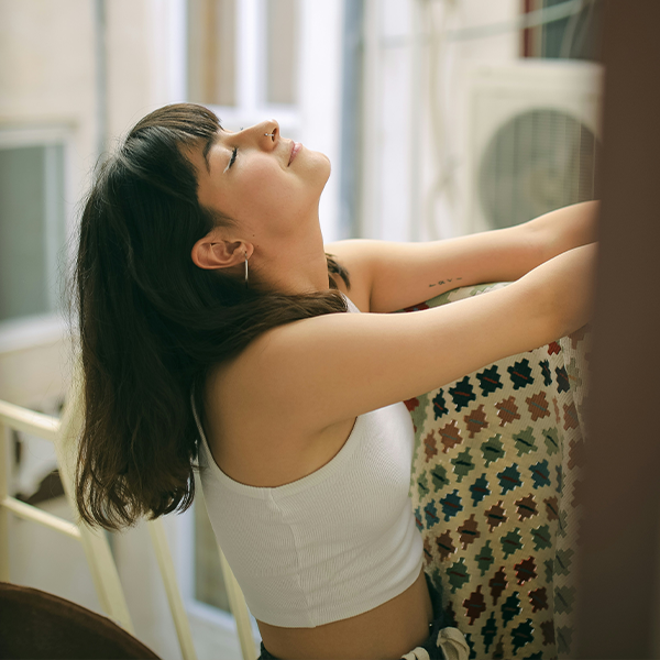 Female taking deep breaths at home