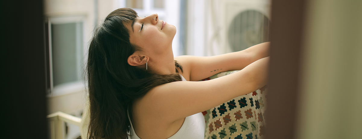 Female taking deep breaths at home