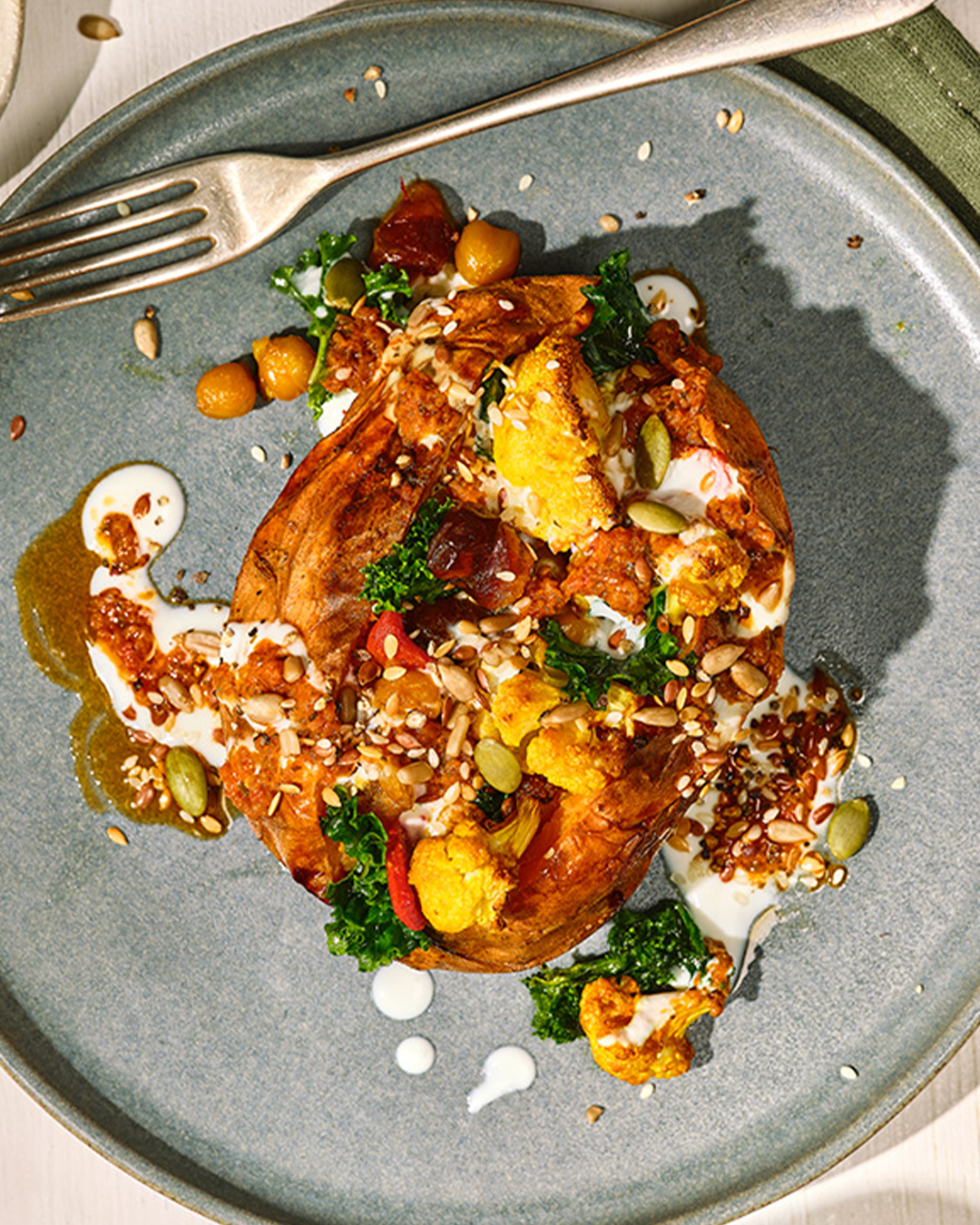 Portion of roasted sweet potatoes on grey plate