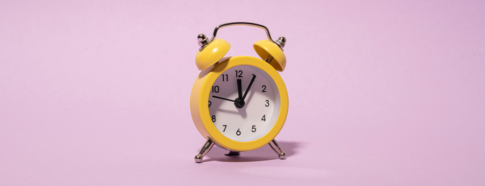 alarm clock on pink background