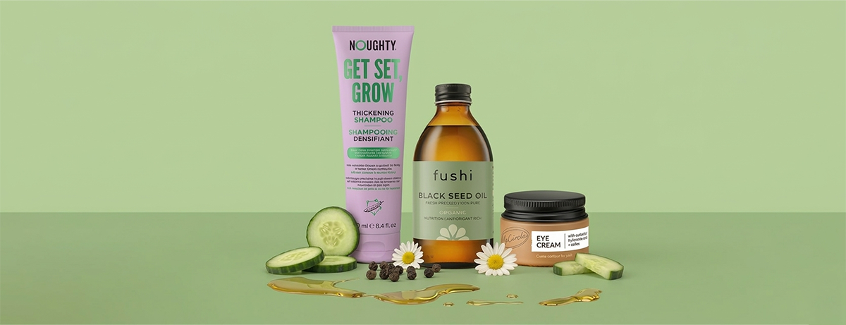 Selection of beauty products on green background