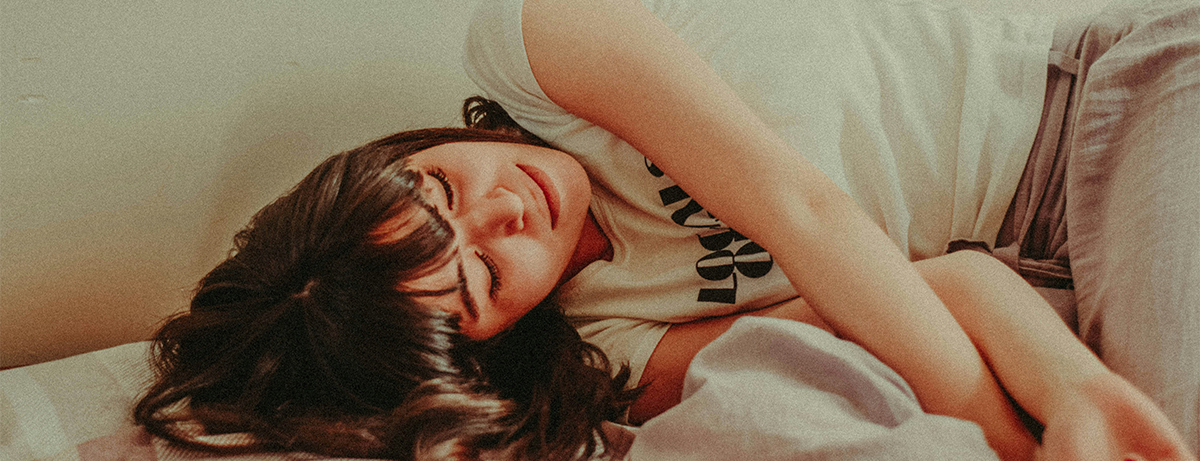Female asleep on bed