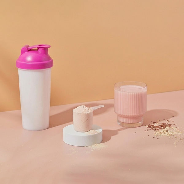 Protein shakes on a pink background