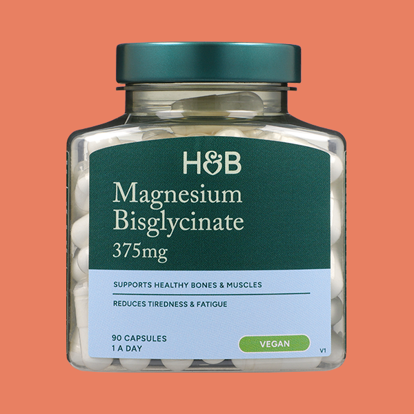 Jar of supplements on coloured background