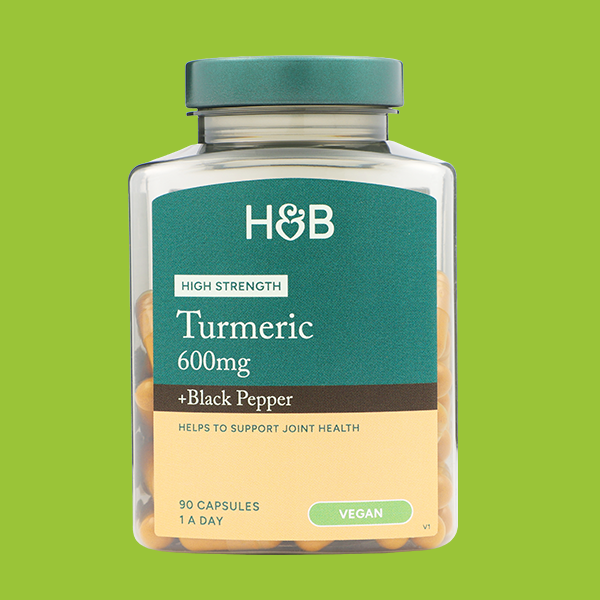 Jar of supplements on coloured background
