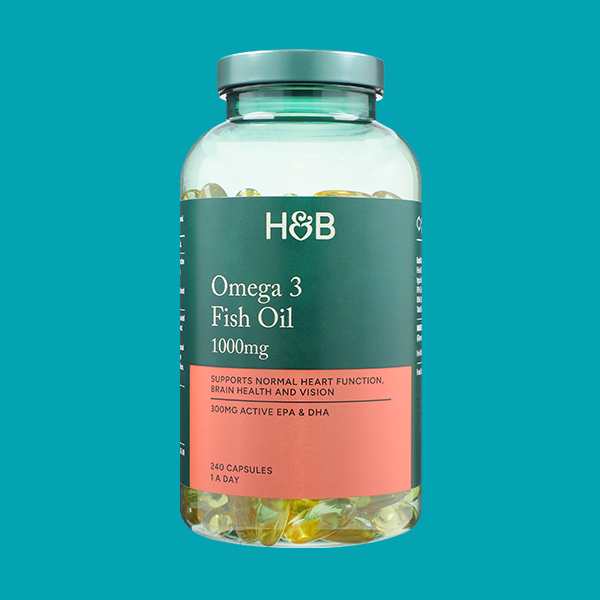 Jar of supplements on coloured background