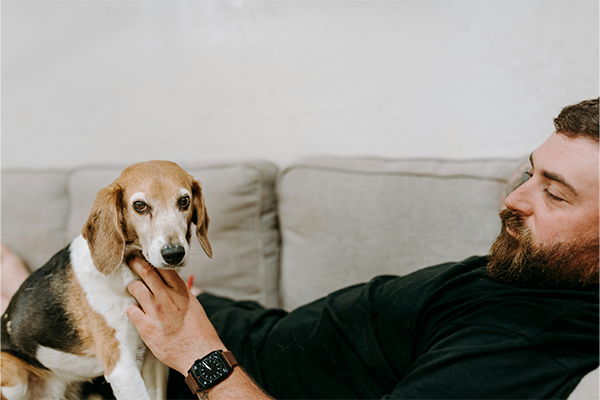 Man an dog relaxing on the sofa