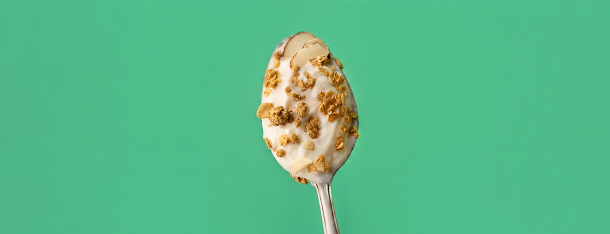 plain yoghurt and nuts on a spoon