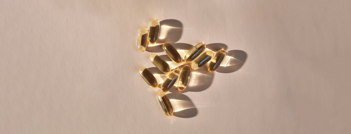 vitamin d supplements on a peach background