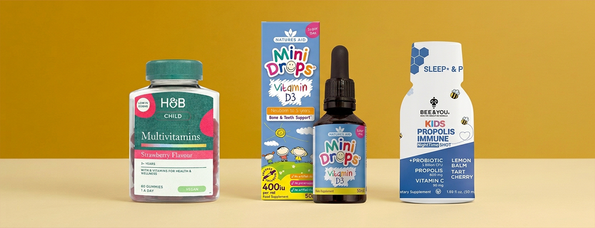 Selection of kids multivitamins on a yellow background