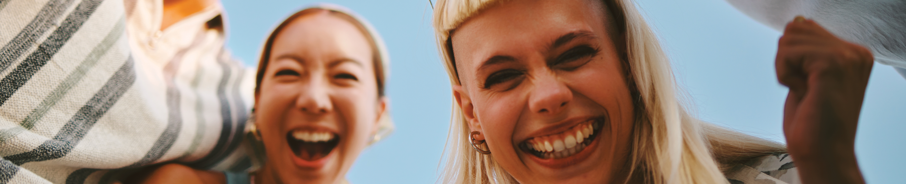 Close up of group of friends laughing at camera