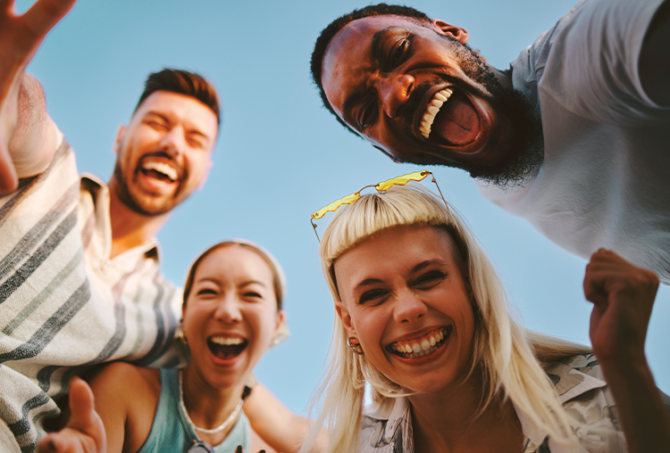 Close up of group of friends laughing at camera