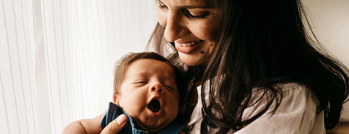 Woman holding a baby smiling