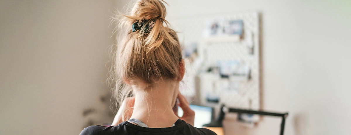 Female standing in front of the camera with hair in an elastic