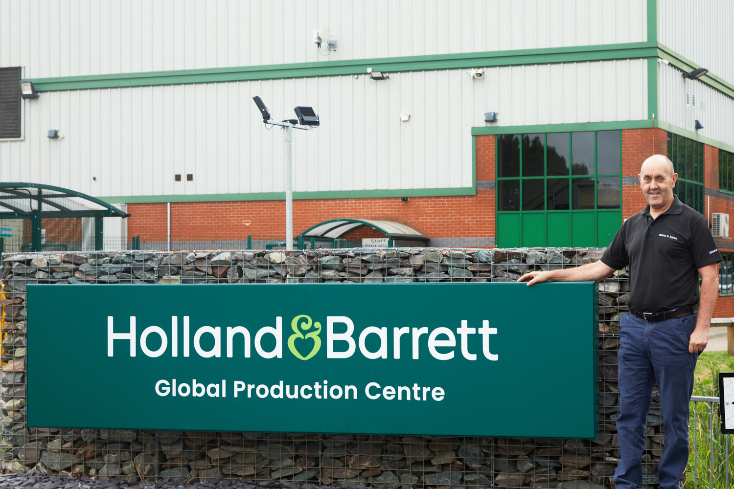 Head of Production next to the Global Production Centre sign