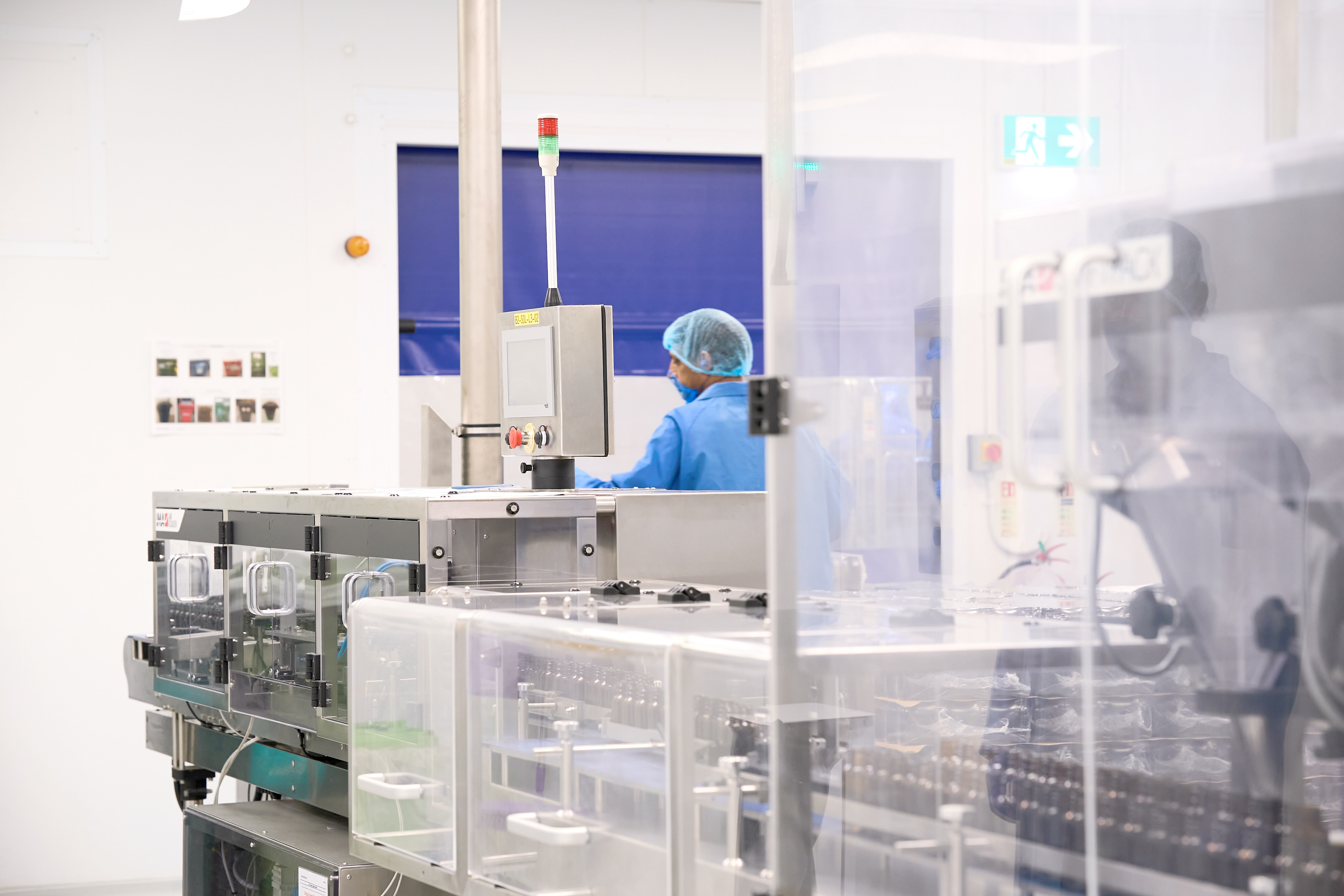 Production Operator in blue gown, hair net and gloves at the start of the production line