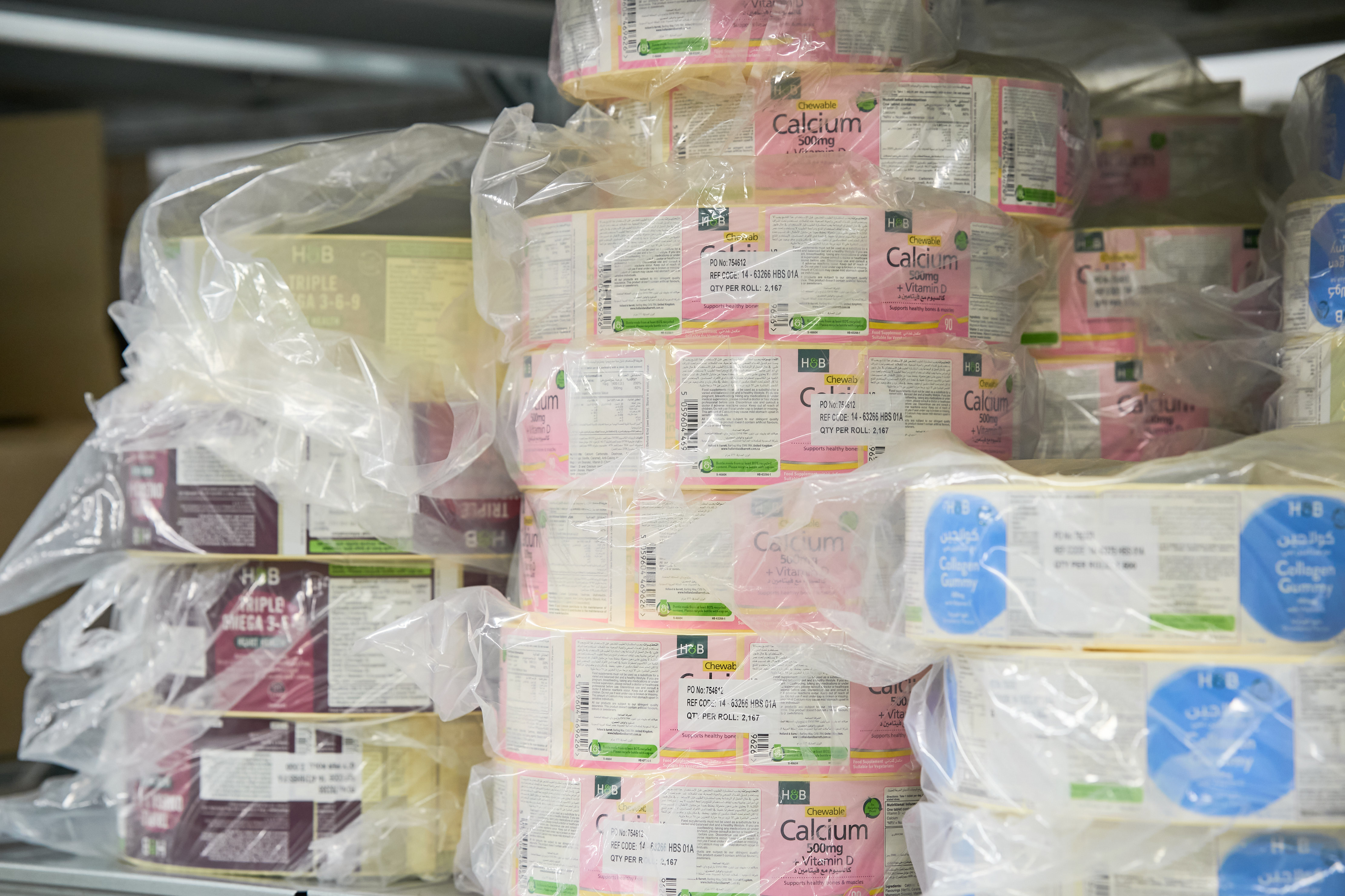 Stacks of white, pink and burgundy label reels