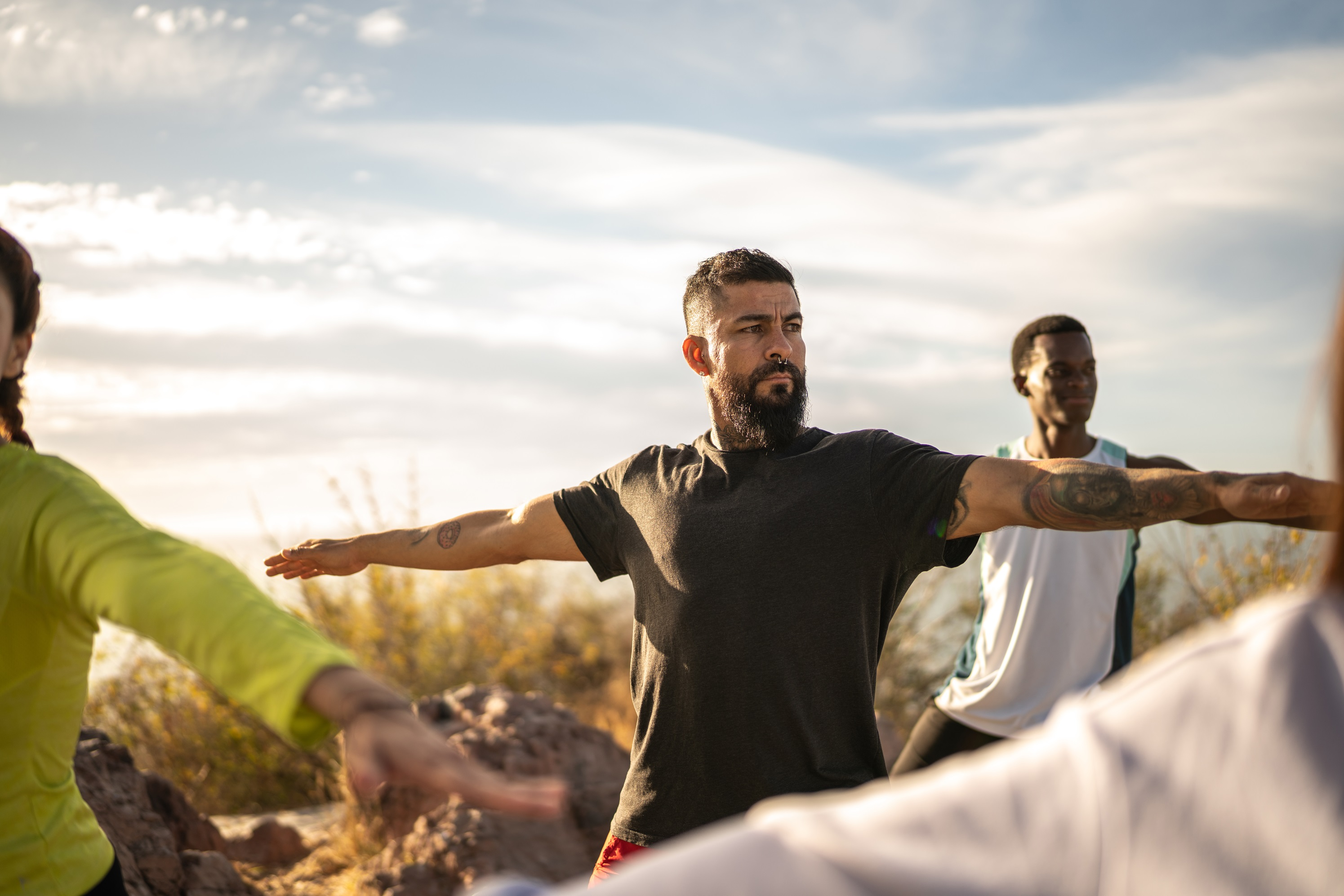 Men doing yoga outdoors