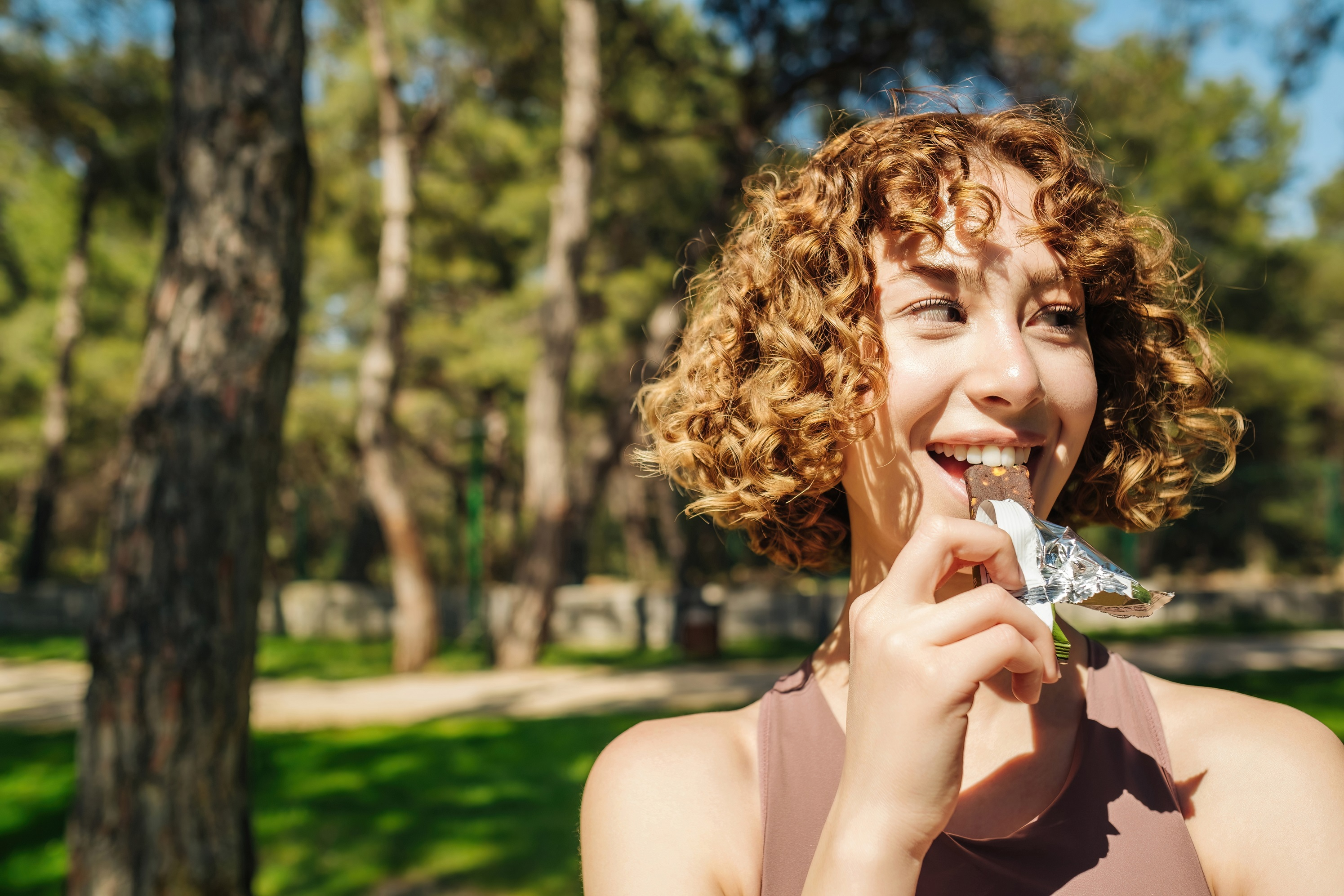 Woman eating a health snack in the park