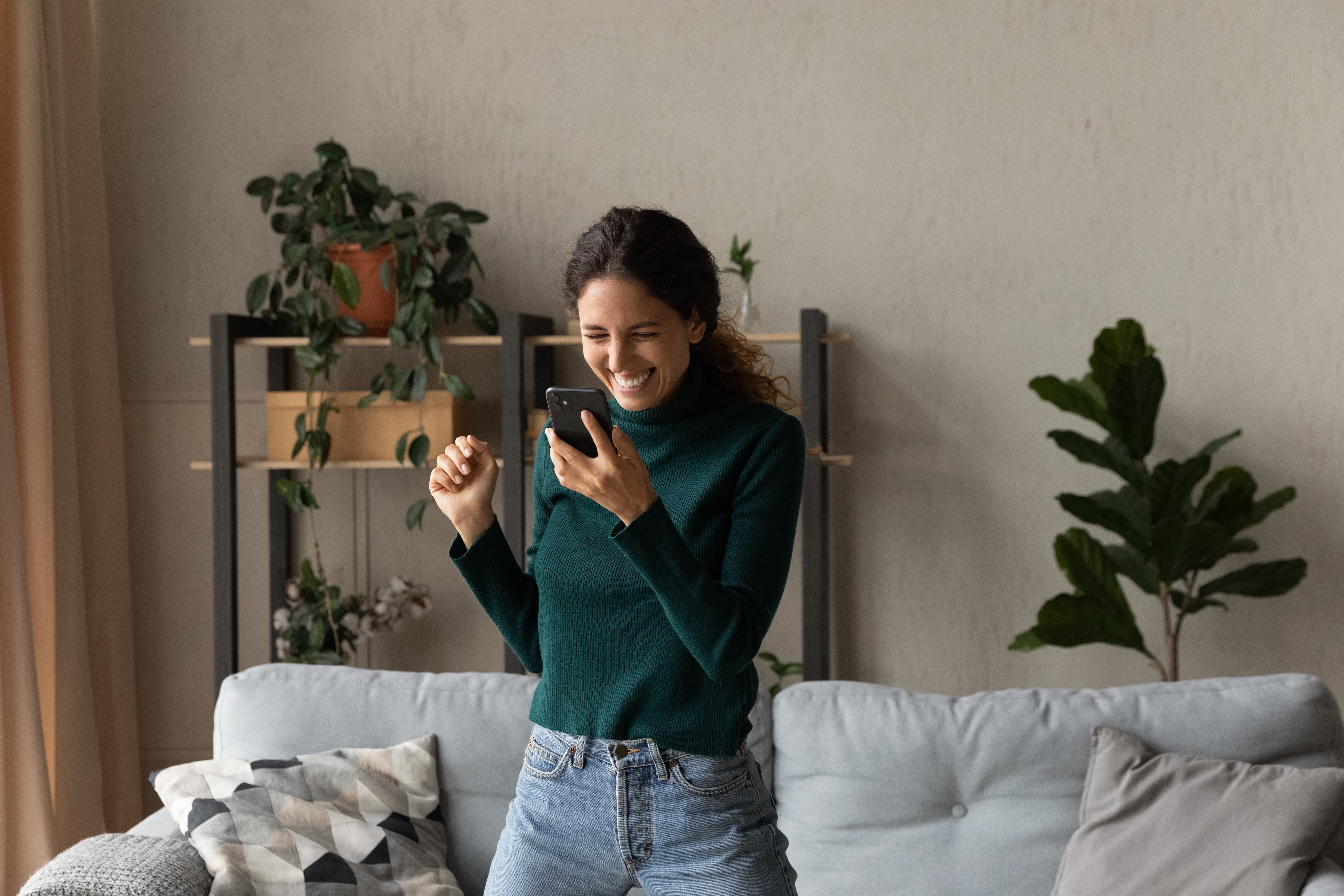 Job applicant smiling and holding a phone