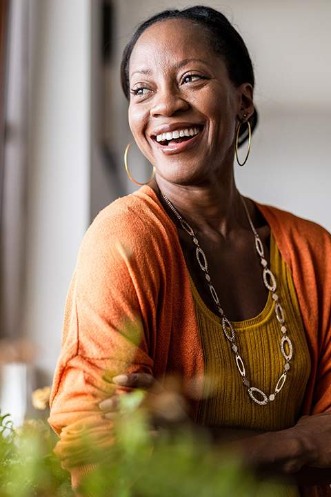 woman smiling looking out the window